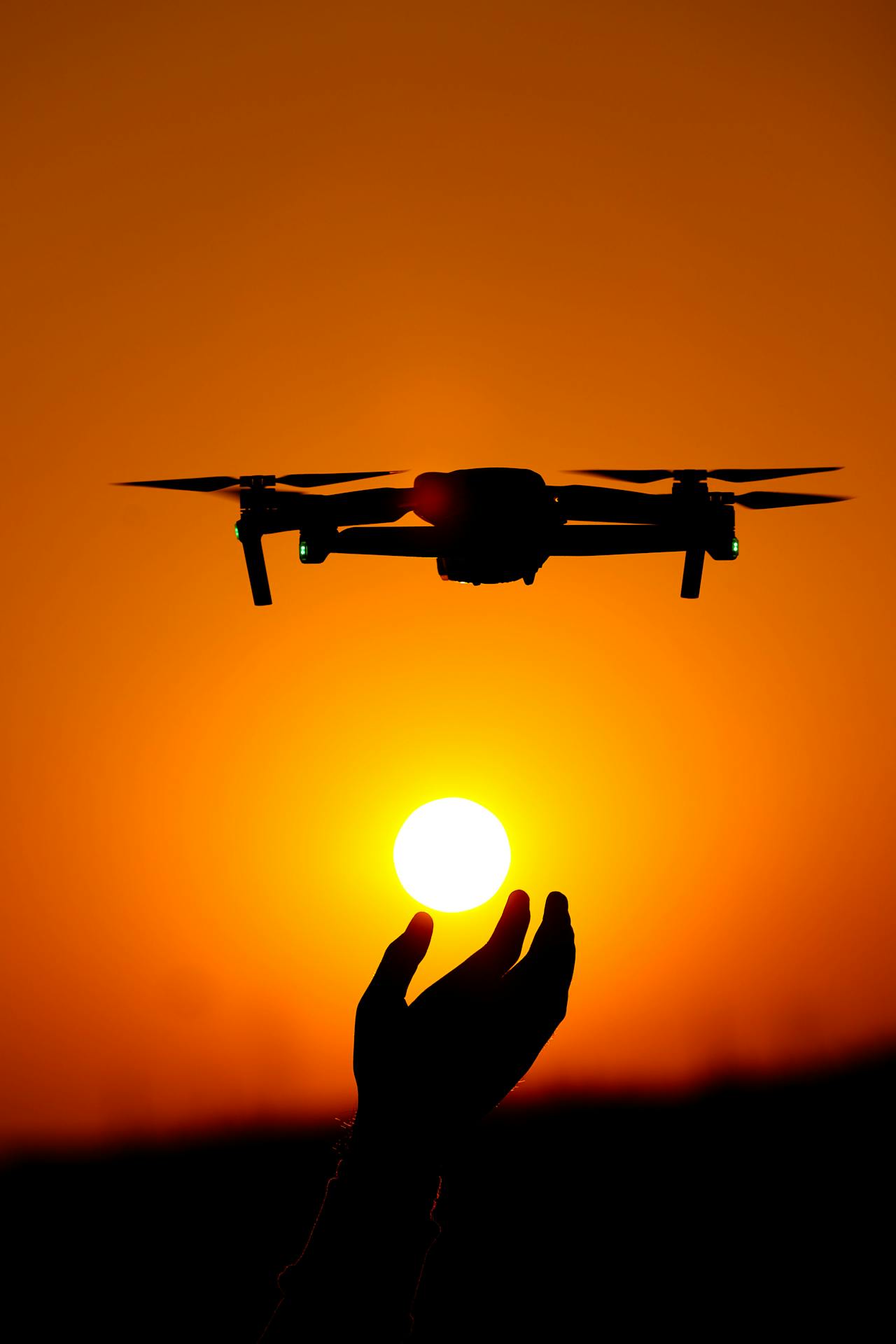 Drone silhouetted against the setting sun